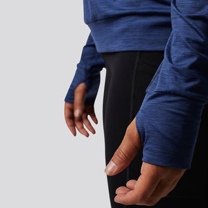 Stylish blue long sleeved warm up gym shirt with an open back and thumb holes.