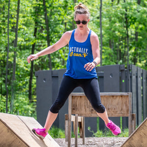 Actually, I can! Young woman jumps from angled platform to platform during out outdoor obstacle race