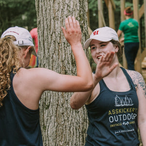 High five! Girl friends congratulating each other after the obstacle race