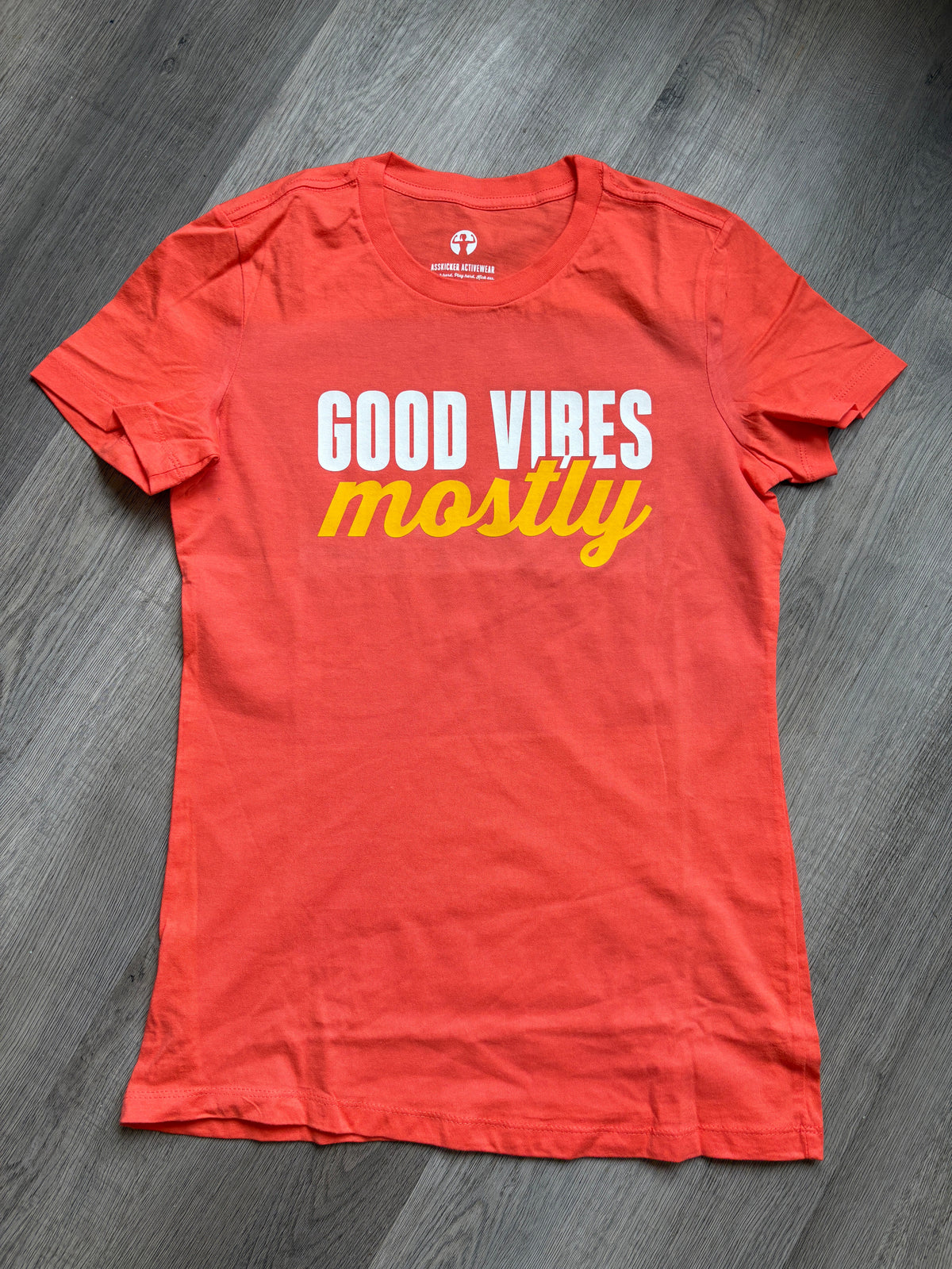Orange t-shirt with words Good Vibes Mostly
