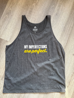 Gray tank top with yellow text on a wooden surface