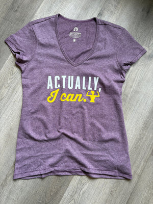 Purple t-shirt with text on a wooden floor