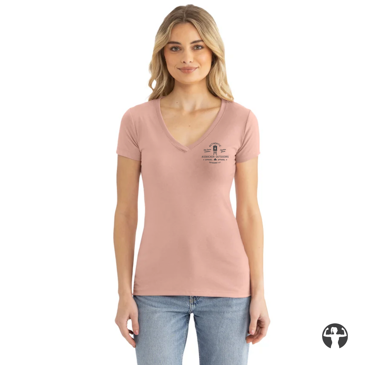 A woman modeling a light pink v-neck t-shirt with a small black graphic on the left chest, paired with blue jeans, against a plain white background.