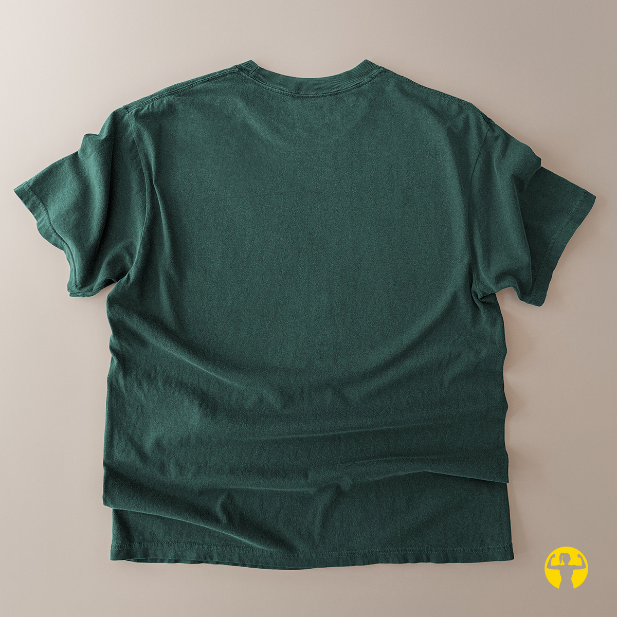 A dark green short-sleeve t-shirt shown from the back, laid flat on a light beige background.