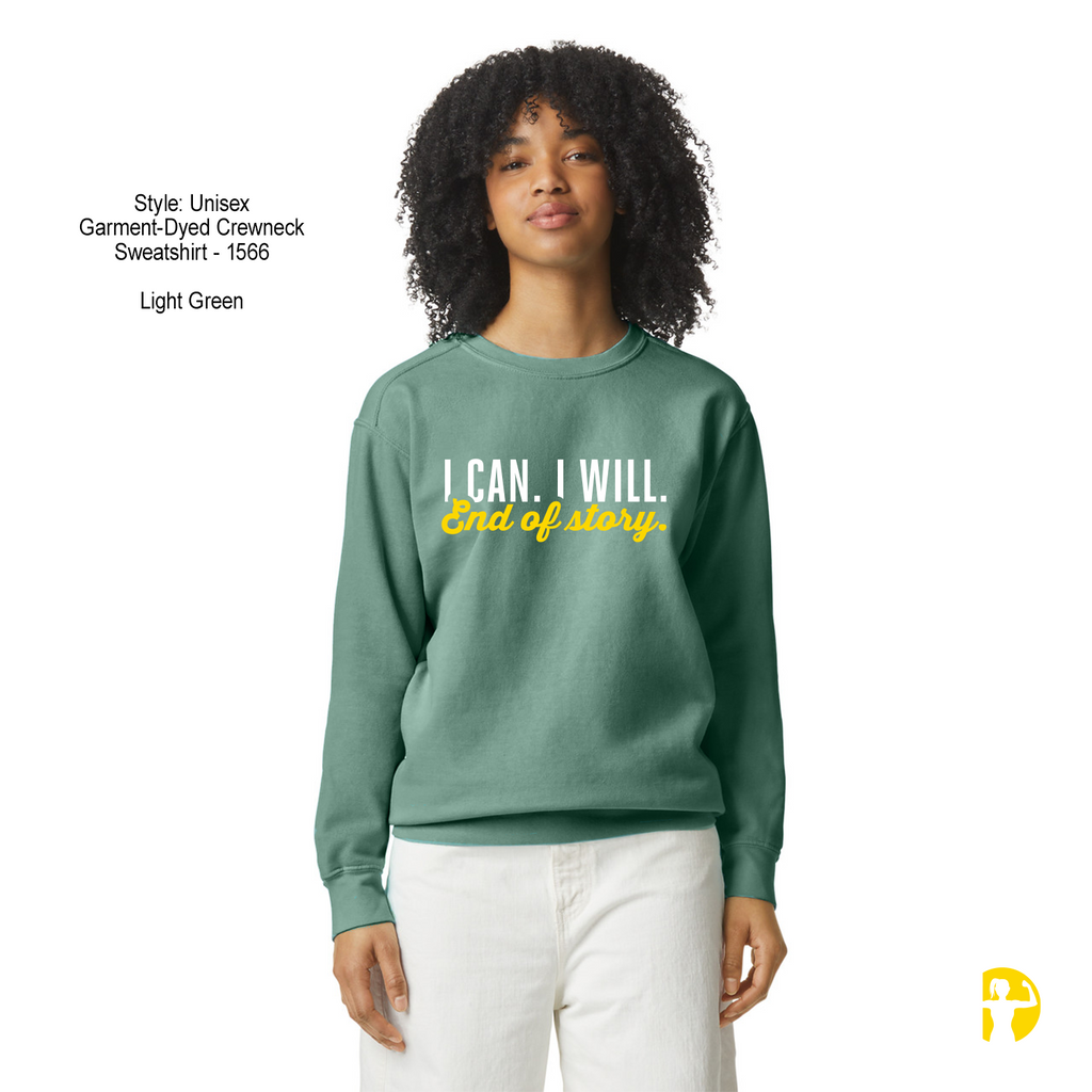 A woman modeling a light green crewneck sweatshirt with the text 'I CAN. I WILL.