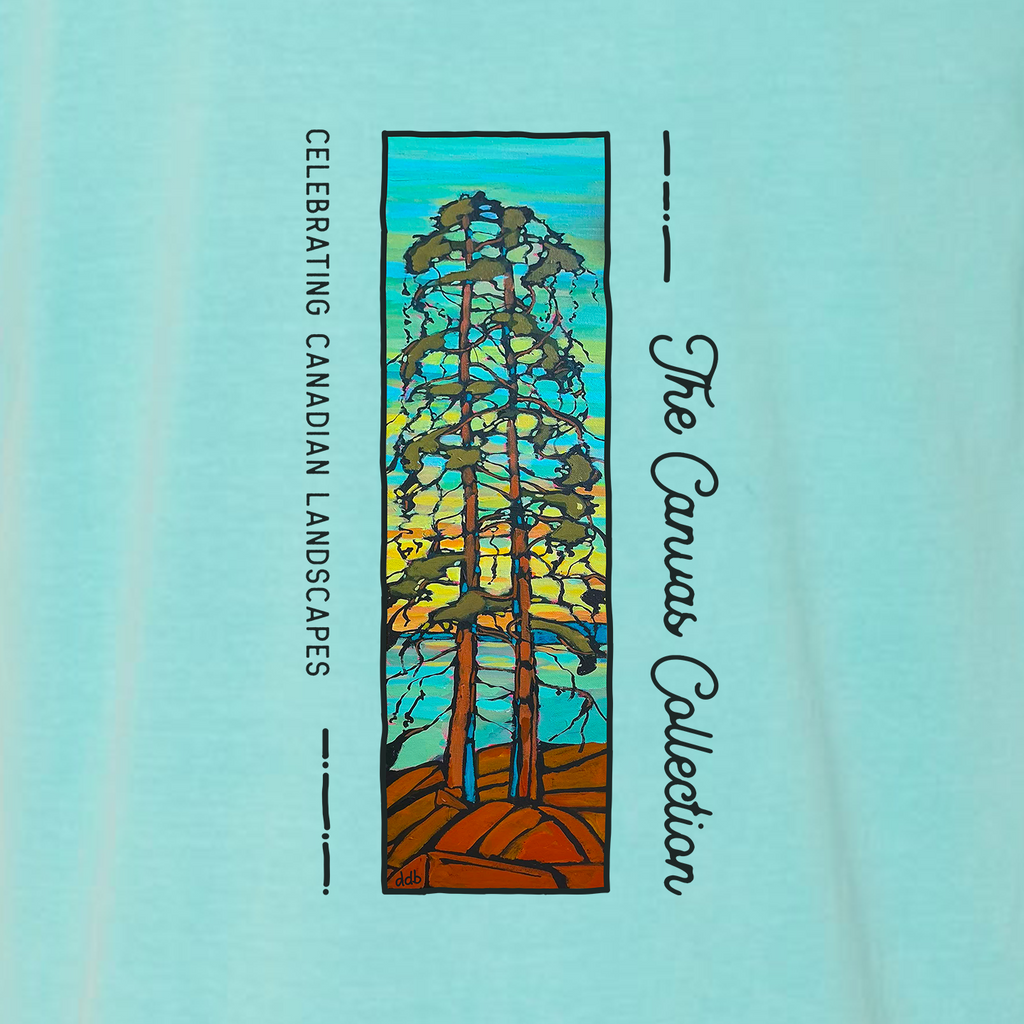 A close-up of a light aqua blue fabric t-shirt, featuring a printed graphic. The graphic displays a vertical stained-glass style illustration of three trees with brown trunks and green foliage against a yellow and blue sky.