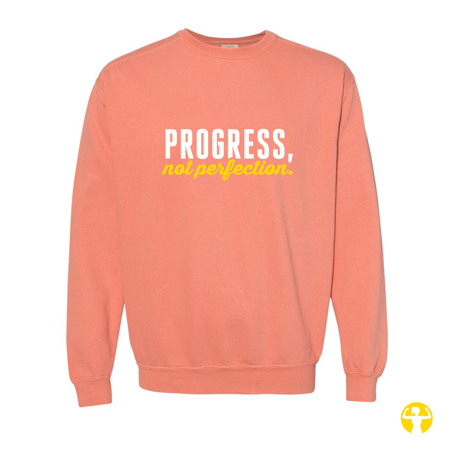 A coral pink crewneck sweatshirt featuring the text 'PROGRESS, not perfection' printed on the chest in white and yellow, displayed against a solid white background.