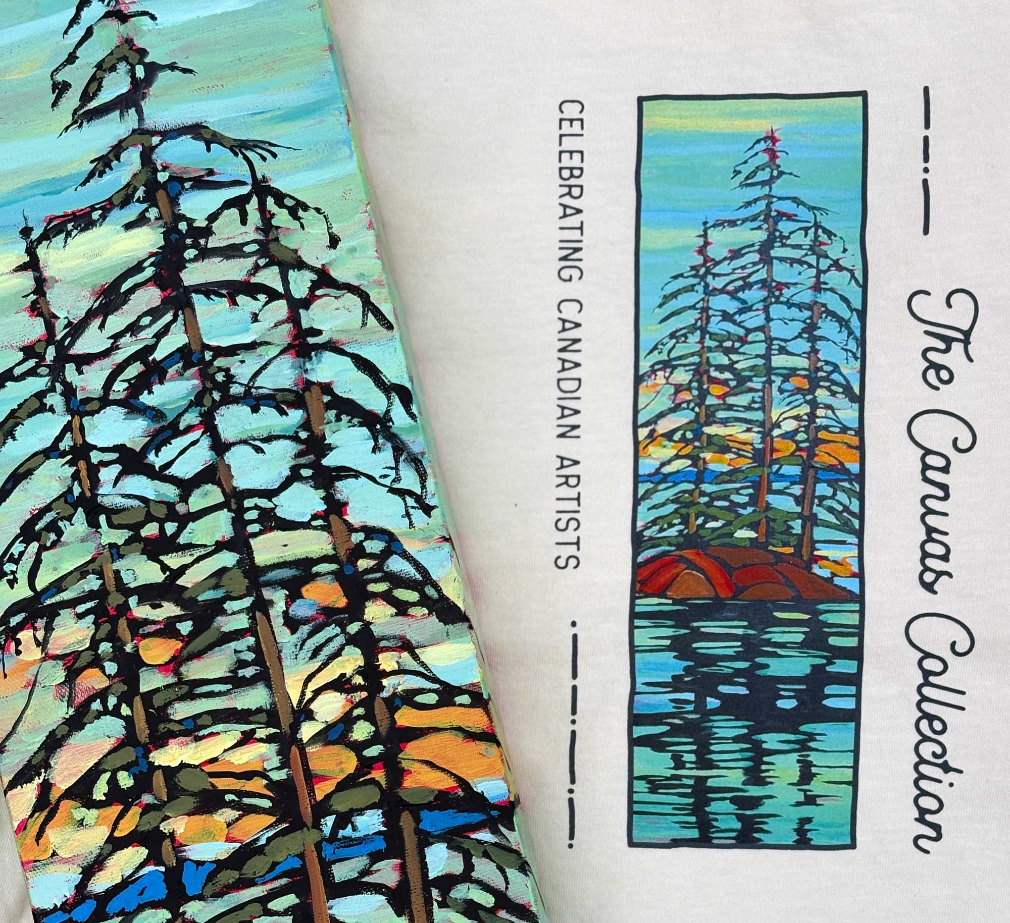 A close-up of a printed t-shirt titled 'The Canvas Collection' with vertical text 'Celebrating Canadian Artists.' The cover features a stylized landscape painting of tall dark trees reflected in blue water, with orange and yellow accents.
