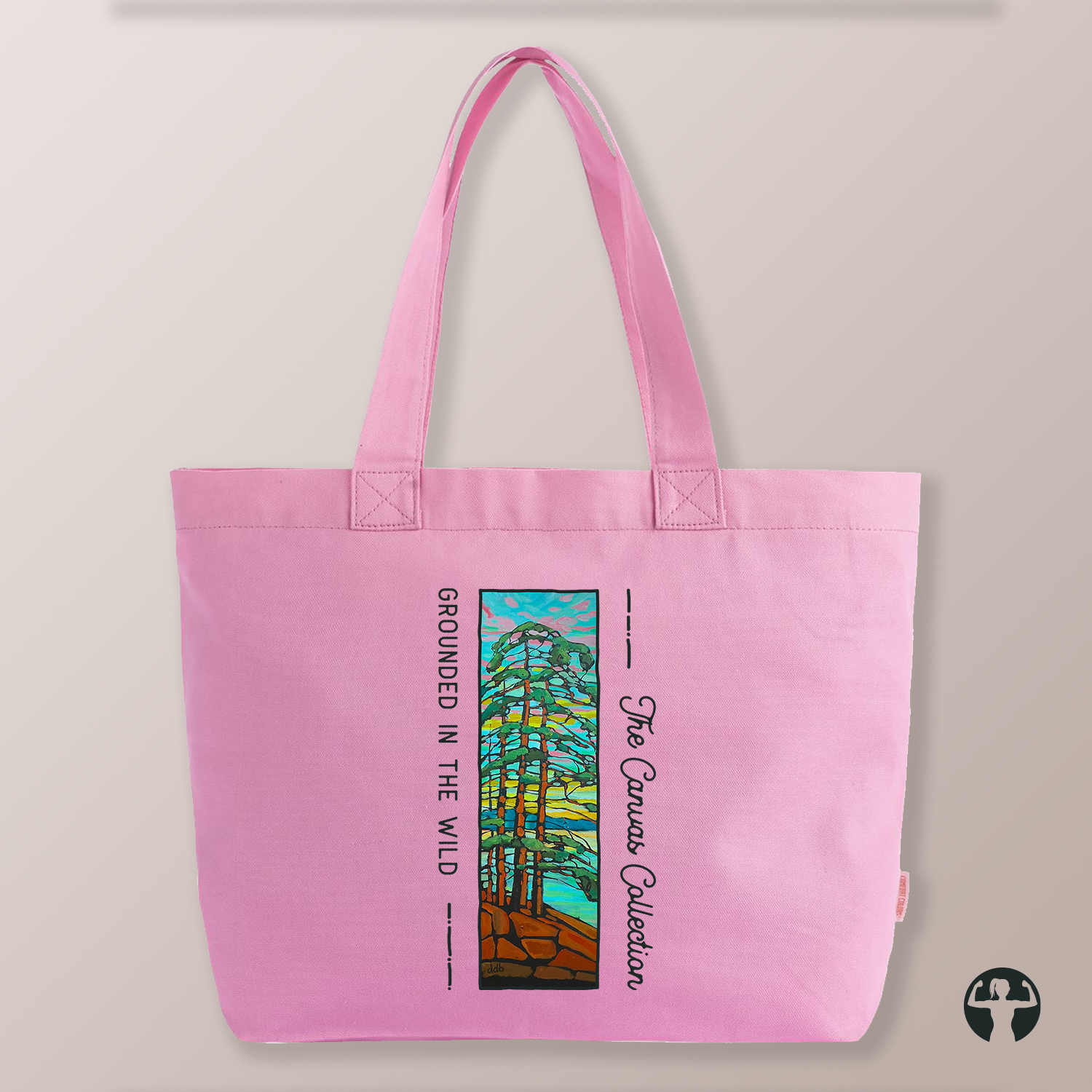 A light pink canvas tote bag with dual shoulder straps, featuring a colourful graphic print of a tree and the text 'The Canvas Collection' and 'Grounded in the Wild' on a neutral beige background.