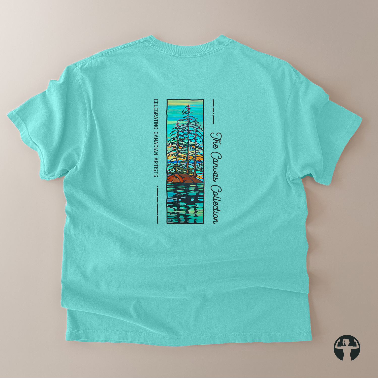A mint green short-sleeve t-shirt laid flat on a light beige background, showing the back side with a colorful graphic print of a stylized tree and the text 'Canvas Collection' and 'Celebrating Canadian Artists'.