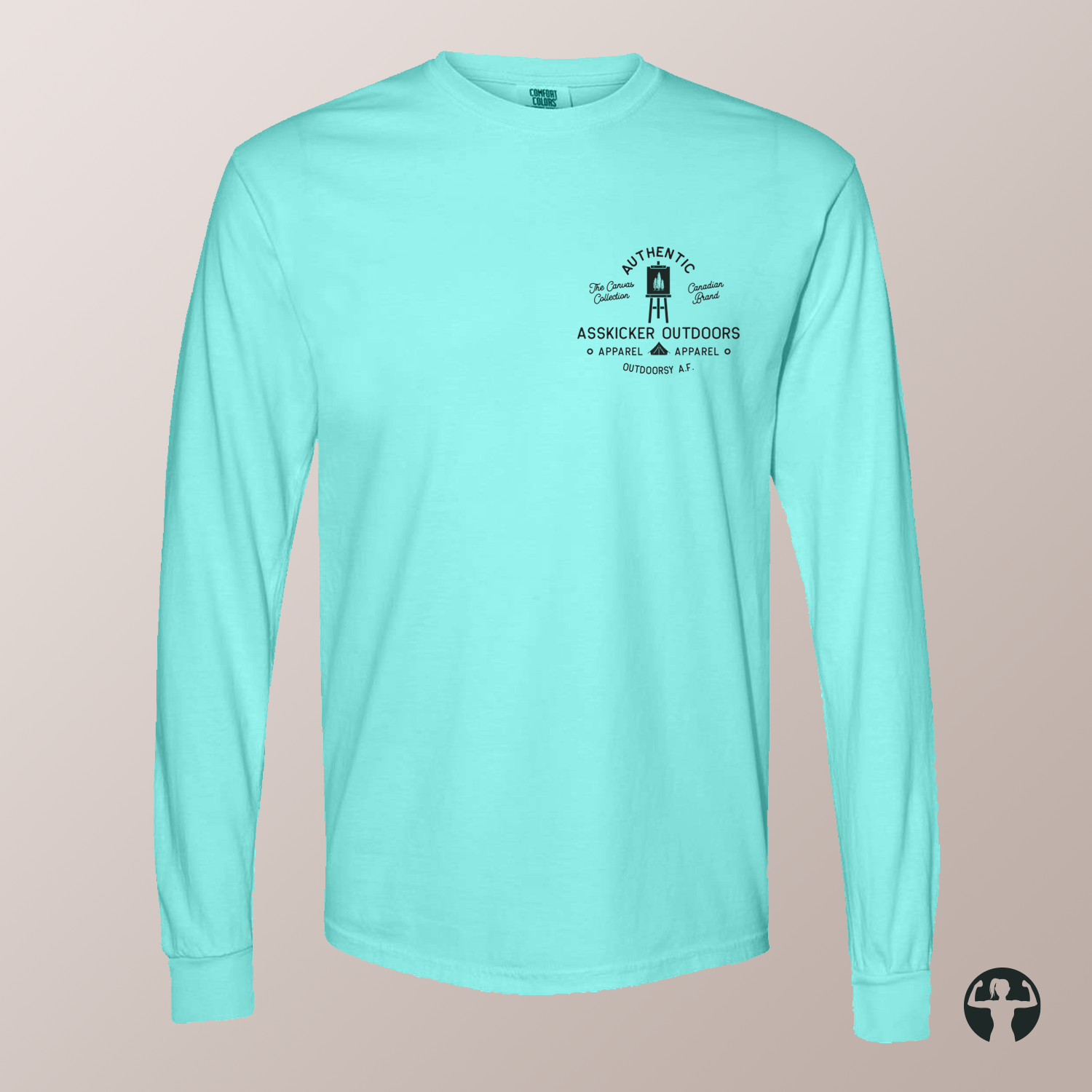 A mint green long-sleeve t-shirt with a black graphic on the left chest, displayed on a neutral beige background. The graphic features a small illustration of a painting easel and camping tent with the text  'Celebrating Canadian Landscapes' and 'The Canvas Collection'.