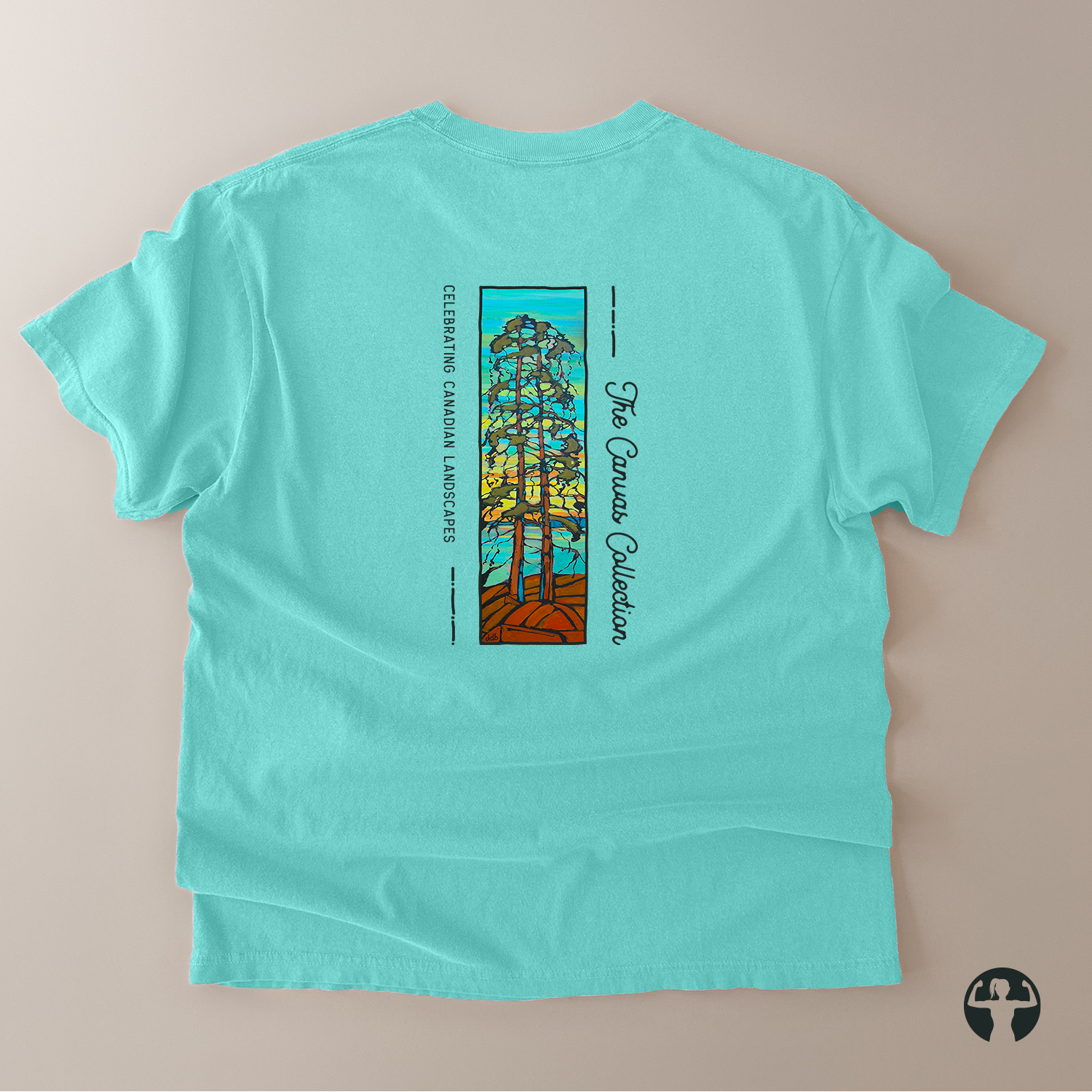 A turquoise short-sleeve t-shirt laid flat on a neutral beige background, showing the back side with a vertical graphic print of a tree in a stained-glass style and the text 'The Canvas Collection' and 'Celebrating Canada's Landmarks'.