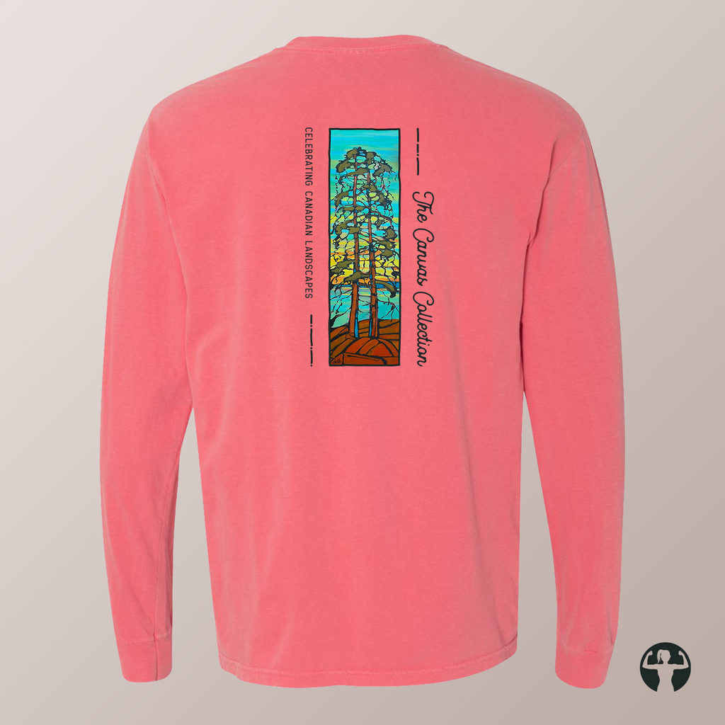 A coral pink long-sleeve t-shirt shown from the back, featuring a vertical graphic print of a stained-glass-style evergreen tree with text reading  'Celebrating Canadian Landscapes' and 'The Canvas Collection'.