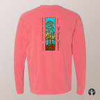 A coral pink long-sleeve t-shirt shown from the back, featuring a vertical graphic print of a stained-glass-style evergreen tree with text reading  'Celebrating Canadian Landscapes' and 'The Canvas Collection'.