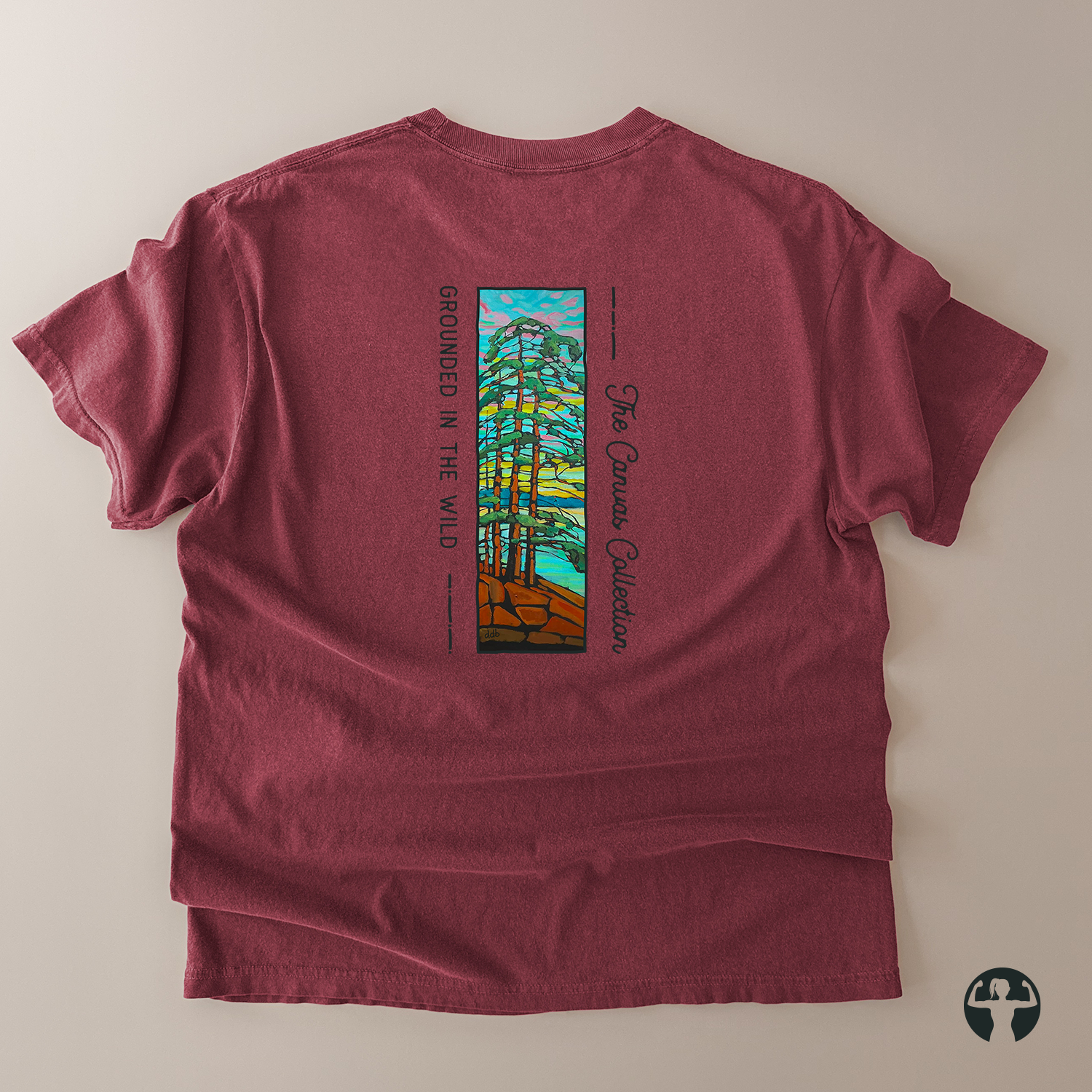 A heathered burgundy t-shirt shown from the back, featuring a colorful graphic print of a forest with the text 'GROUNDED IN THE WILD' and 'The Canvas Collection'.