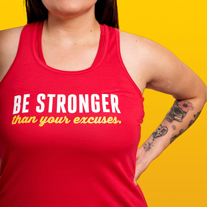BE STRONGER THAN YOUR EXCUSES, FLOWY RACERBACK TANK  $29.99 CAD This is our most popular style because the fabric feels ultra soft and the draped silhouette is flattering on all body types.  Perfect for the gym or casual wear, the light fabric dries quickly and the sheering on the back adds a nice feminine detail. If you prefer a form fitting style, try the Fitted Racerback Tank.