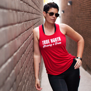 True North Strong & Free - Red Canada Day Tank top from a Canadian Brand . Showcase Canadian pride in comfort and style with our True North Strong & Free tank top. Made of ultra soft fabric and flowy fit, this tank is flattering on any body shape and perfect for gym or casual wear. The light fabric dries quickly and the sheering on the back adds a nice feminine touch - chillax, eh?!