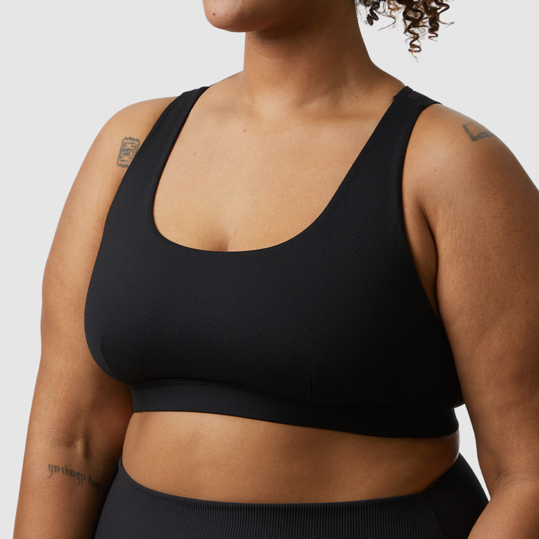 Born Primitive took their beloved X-Factor sports bra and increased the front coverage to allow for more overall coverage and support. It also features an extended body fit that is beyond flattering on curvy body types. Black sports bra for plus size women.